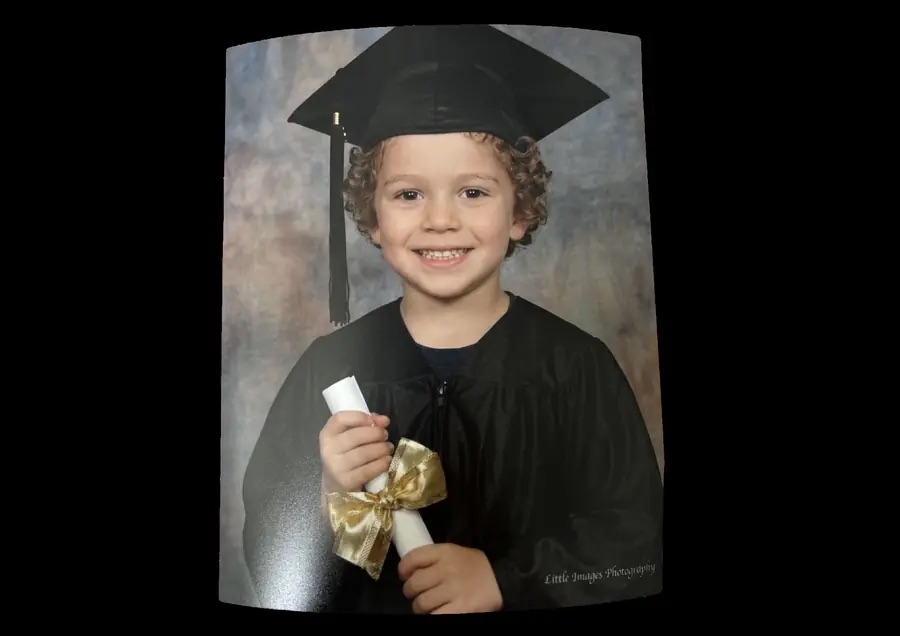 Large portrait print of a child photographed in cap and gown
